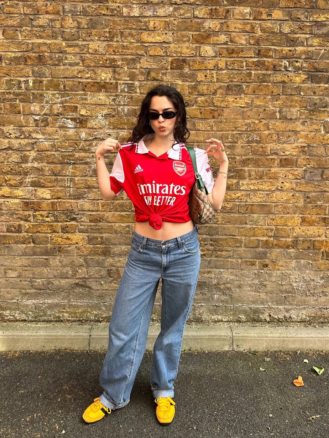 Red jersey styled with relaxed jeans and sneakers
