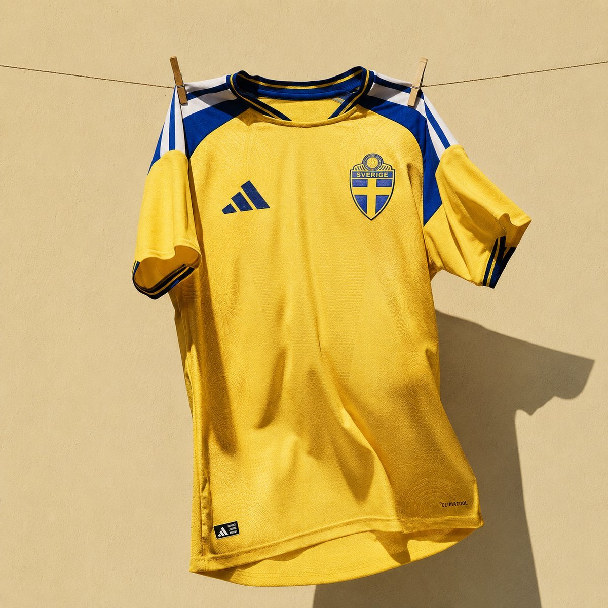 Yellow federation home shirt with adidas branding hung on a clothesline, full front view