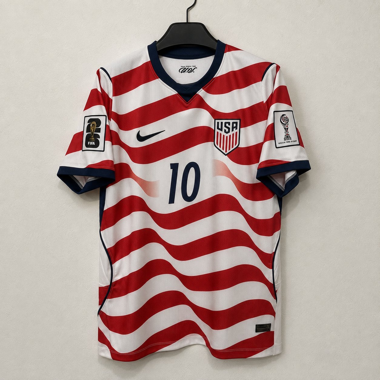 Match-tier USWNT Stripes home shirt on a hanger, with FIFA matchday sleeve badges